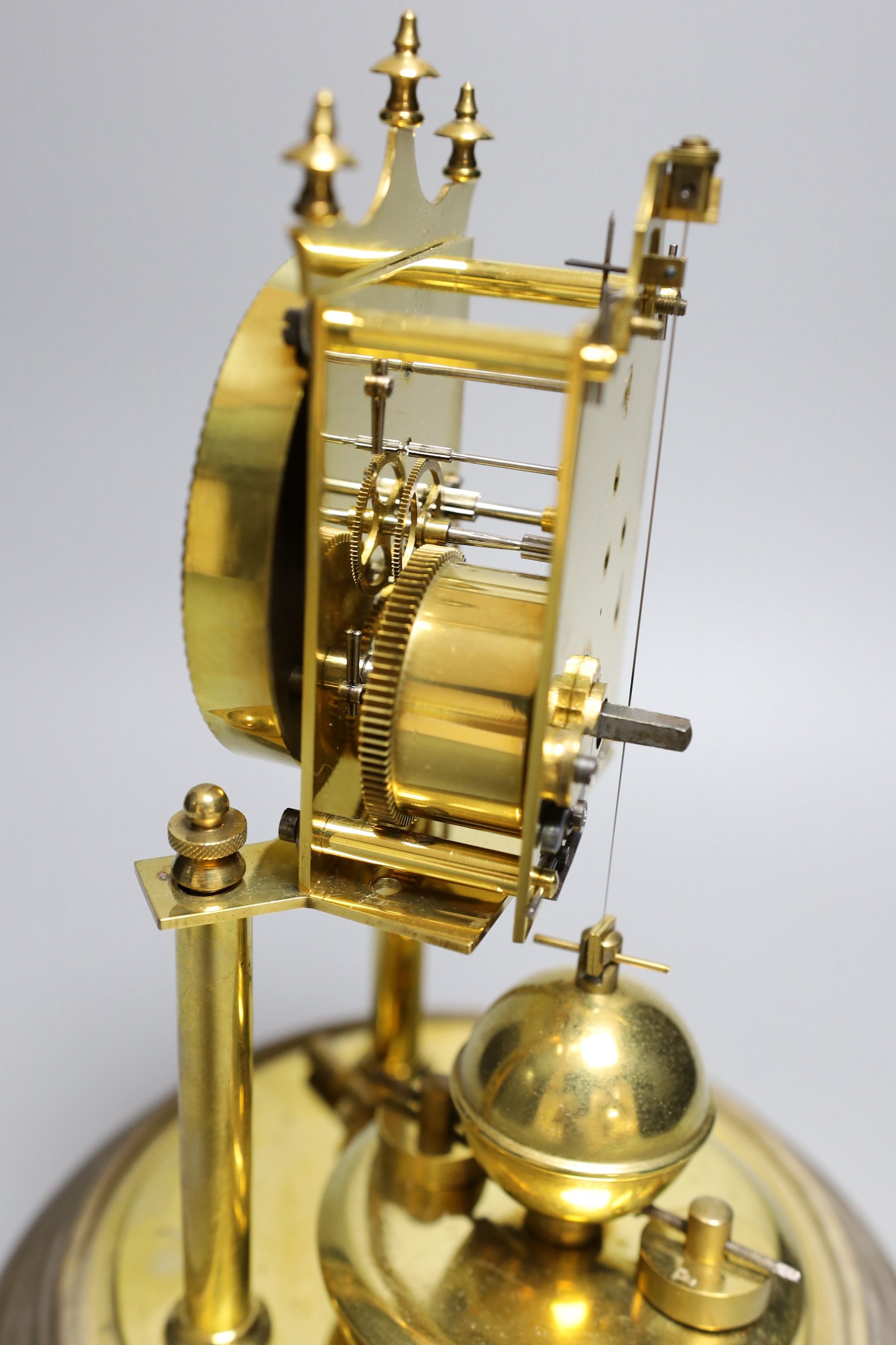 A German 400 day brass mantel timepiece, under a glass dome 29cm total height